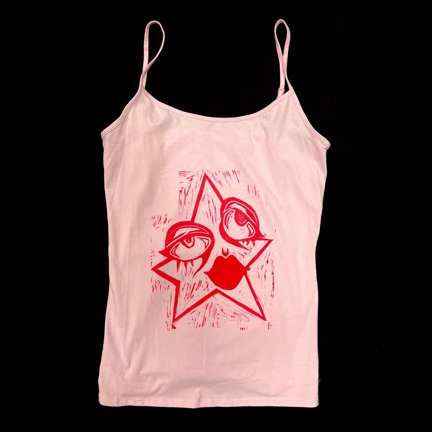 baby pink cami with dark print cartoon star graphic