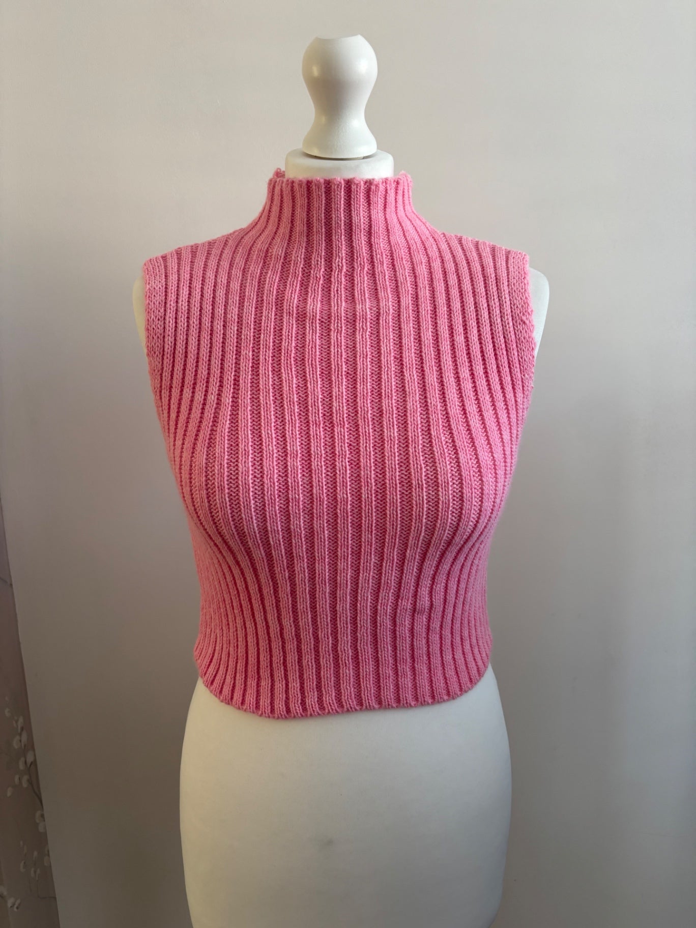 Pink knitted turtle neck sleeveless top