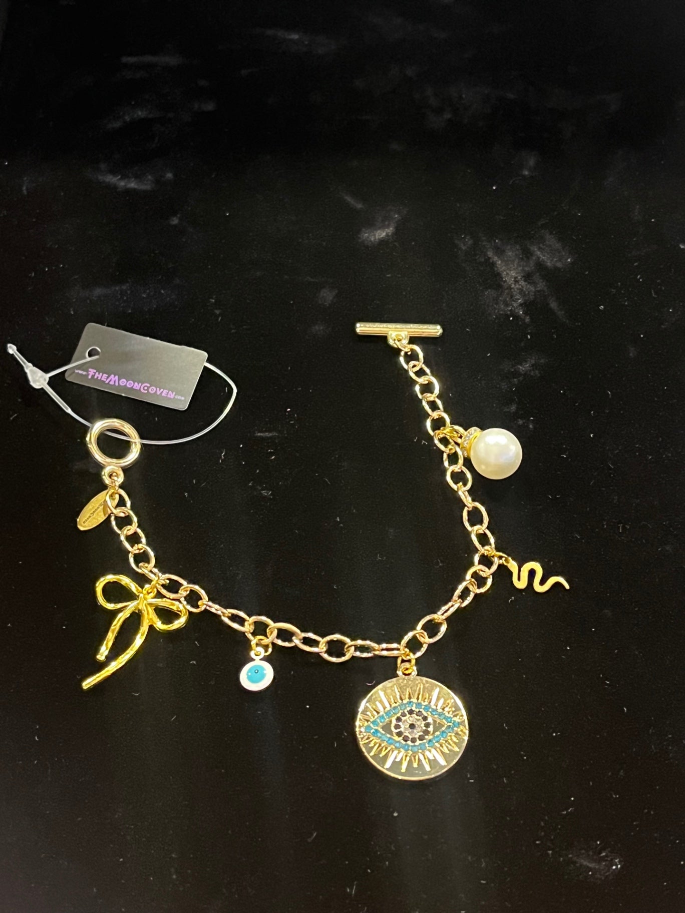 Mystic Bow & Evil Eye T-Bar Charm Bracelet – Gold