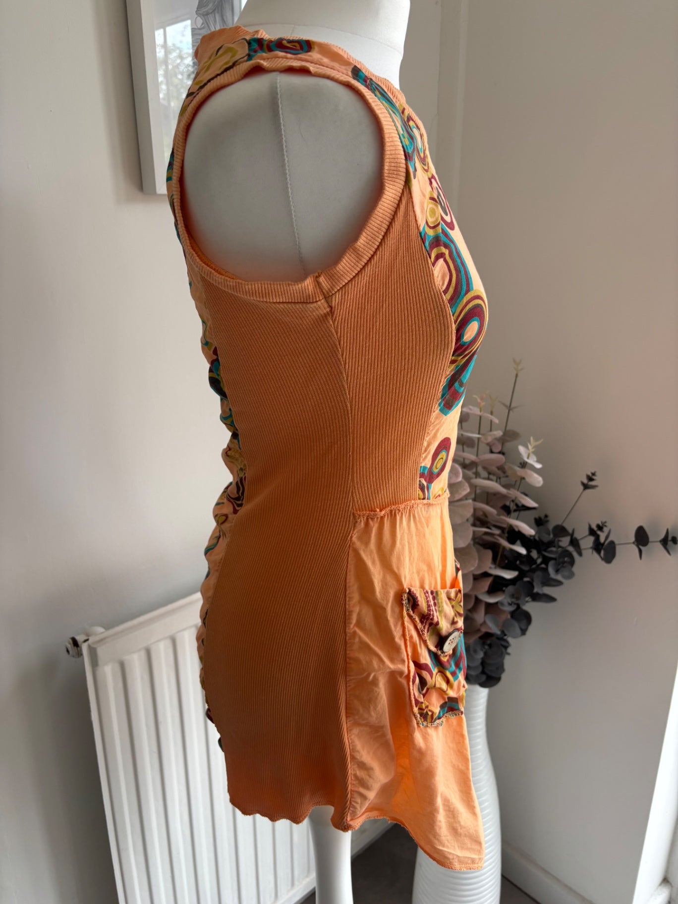 Orange shirt top with colourful swirls