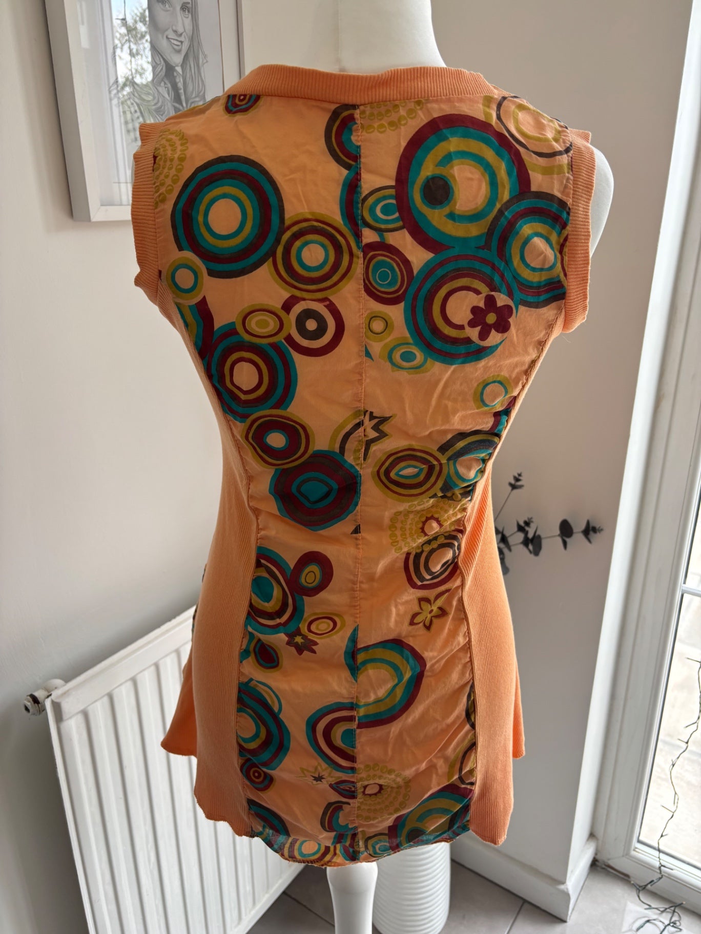 Orange shirt top with colourful swirls
