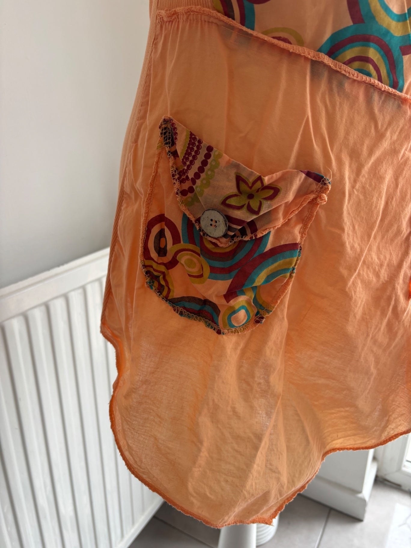 Orange shirt top with colourful swirls