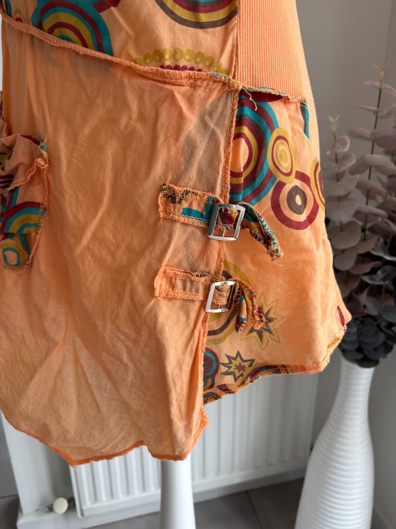 Orange shirt top with colourful swirls