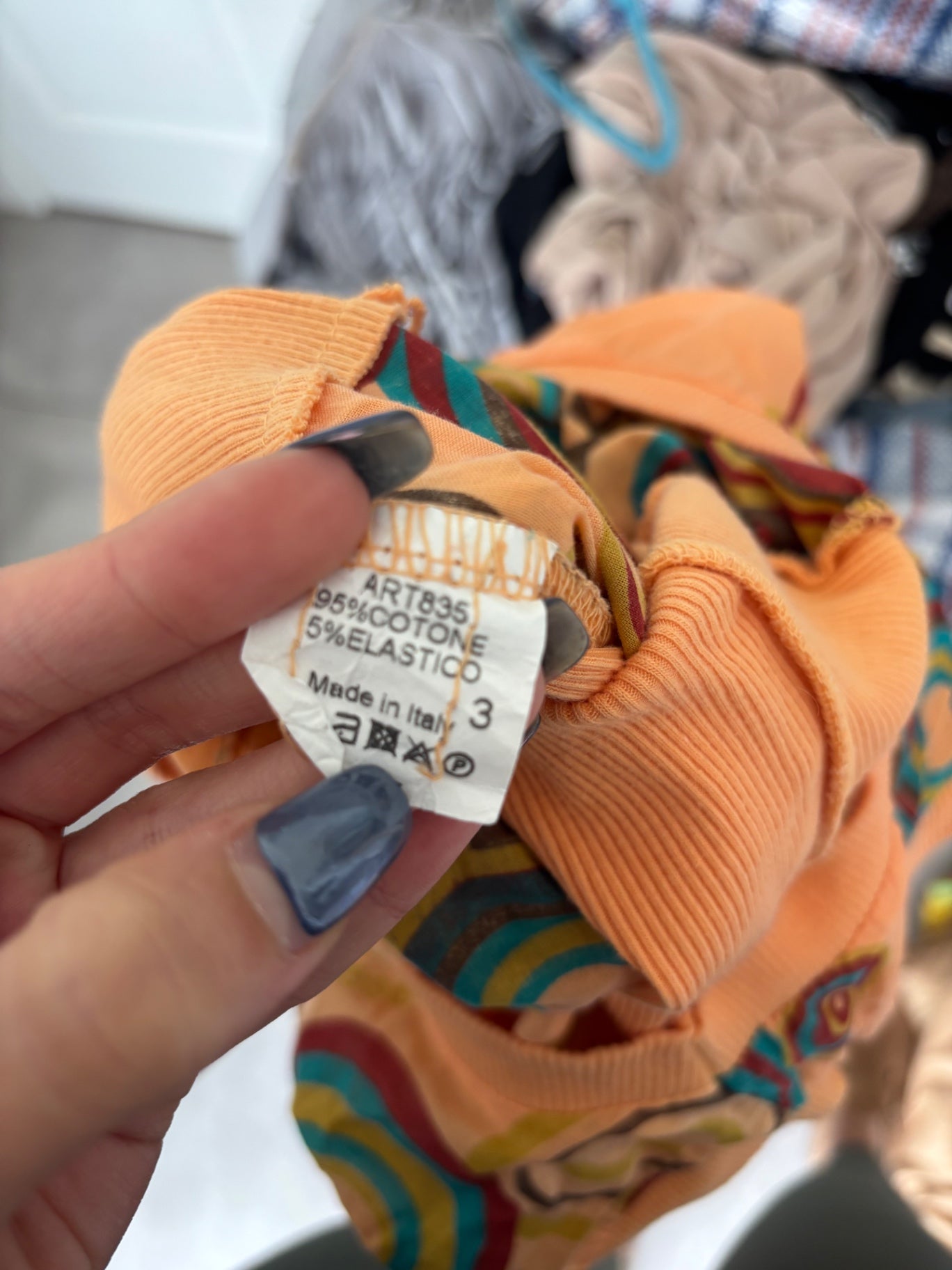 Orange shirt top with colourful swirls