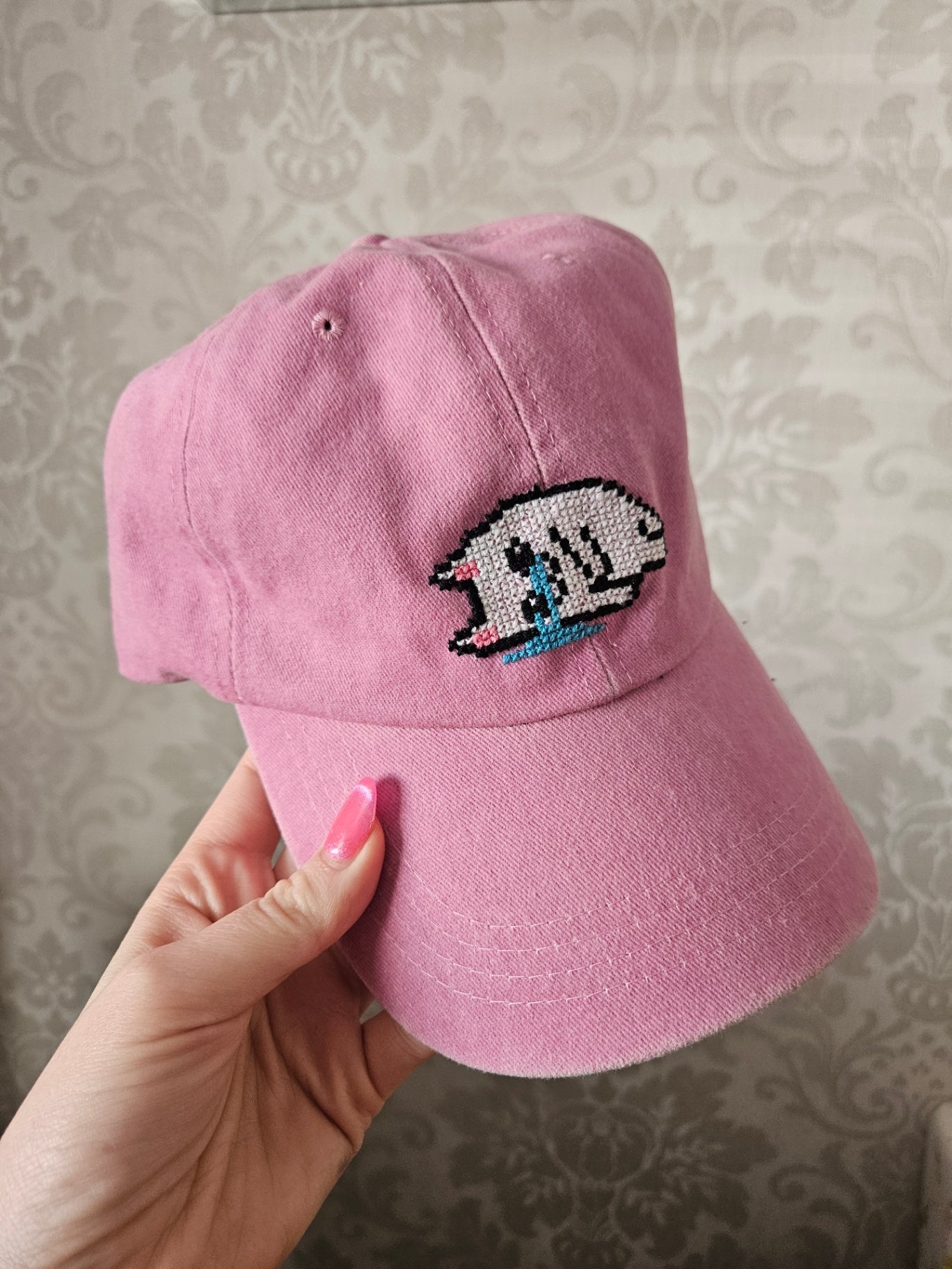 Pink cross stitched sad kitty cap