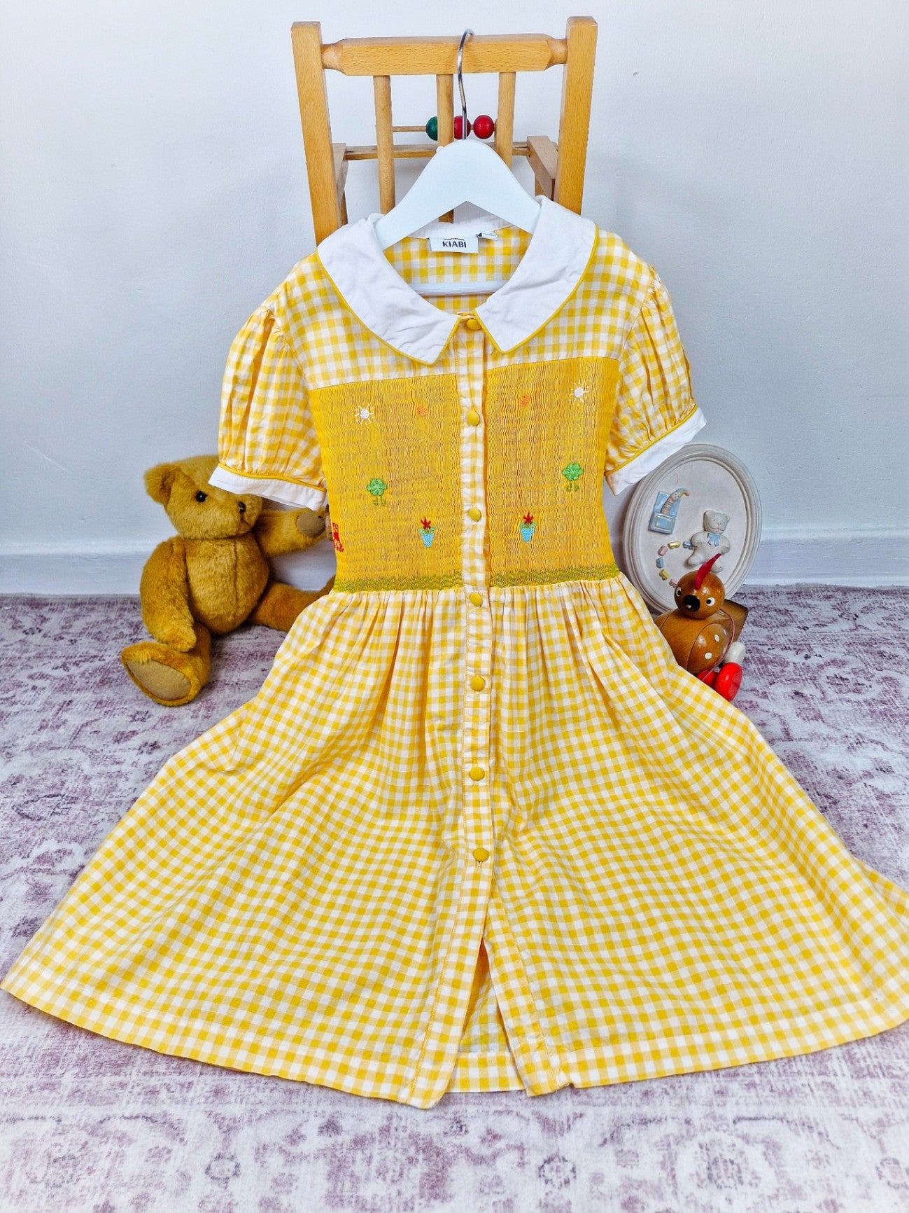 Yellow and white button down gingham smock dress with embroidered designs