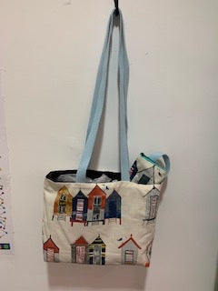 Beach huts with small extra attached purse. Long pale blue handles 