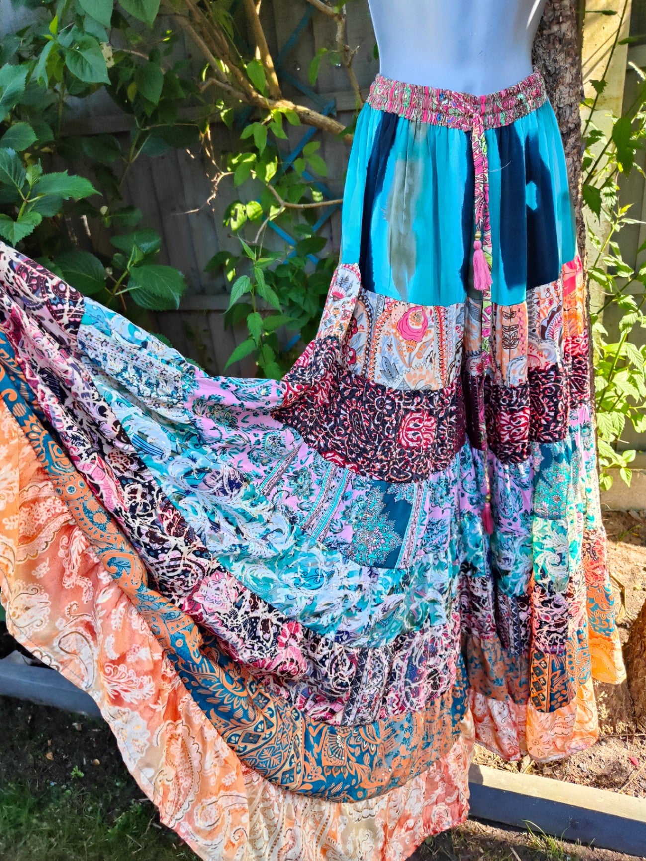 Patchwork flares with pink tassel ties
