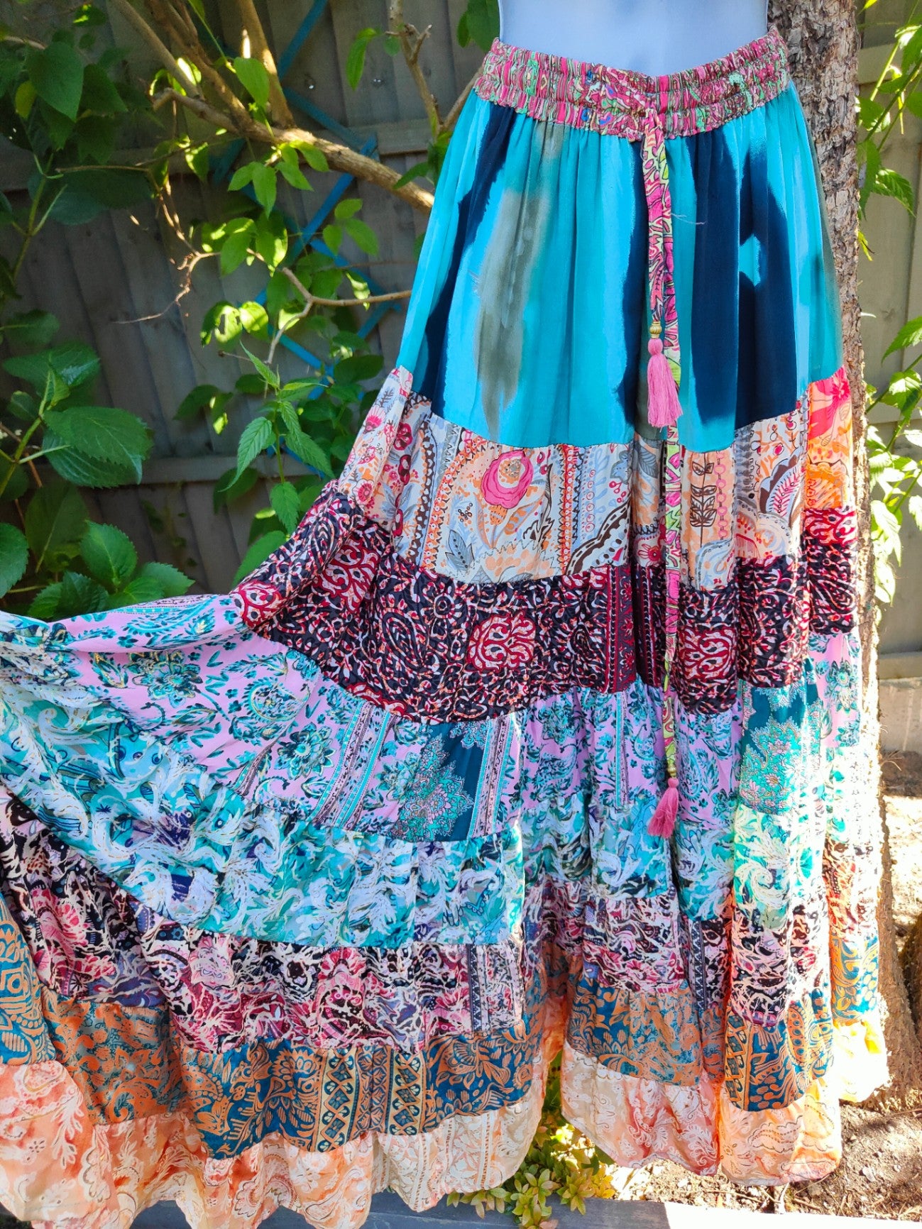 Patchwork flares with pink tassel ties