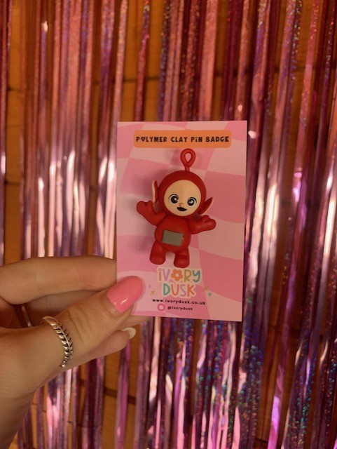 red tubby polymer clay badge