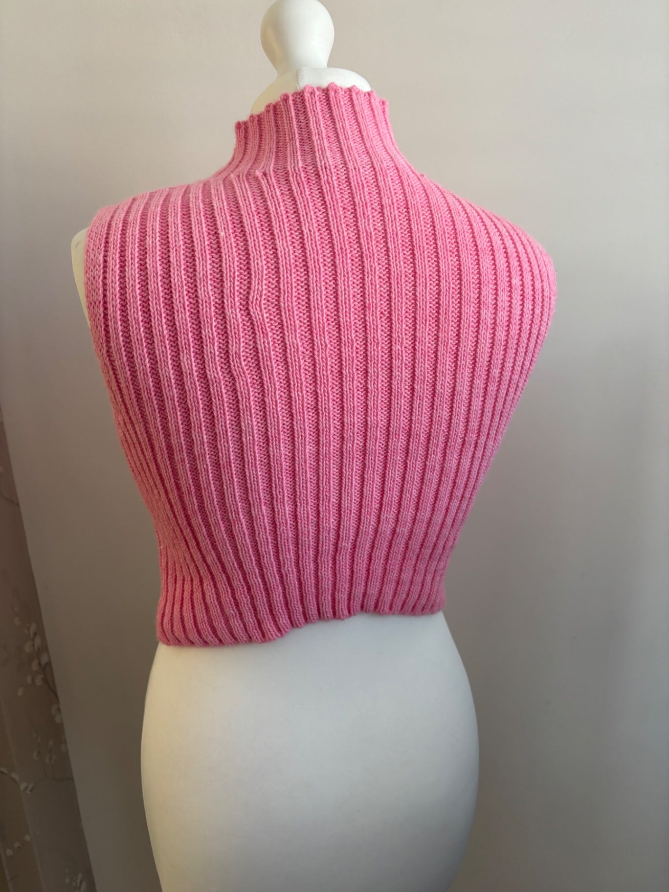 Pink knitted turtle neck sleeveless top