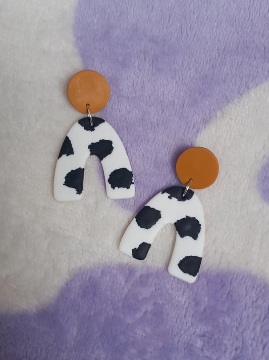 Polymer clay cow print arch earrings