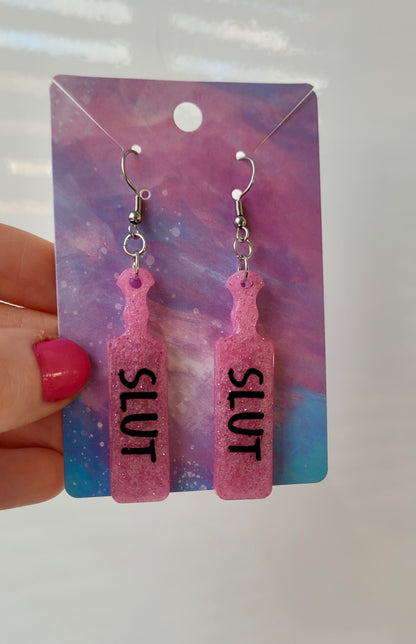 Pink Glitter Paddle Earrings – “SLUT” Indent Text – Alt NSFW Statement Jewellery