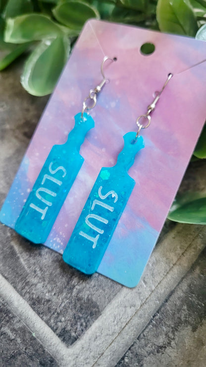 Turquoise Blue Glitter Paddle Earrings – “SLUT” in White Text | Handmade Alt Resin Jewellery