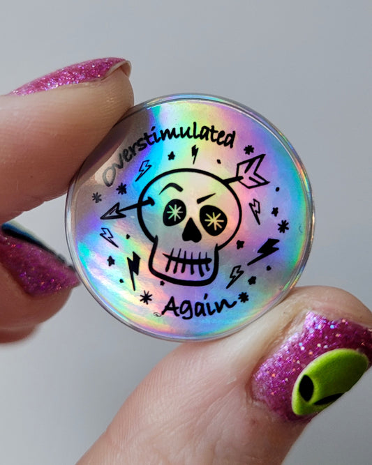 “Overstimulated Again” Holographic Skull Badge – Neurodivergent Alt Pin