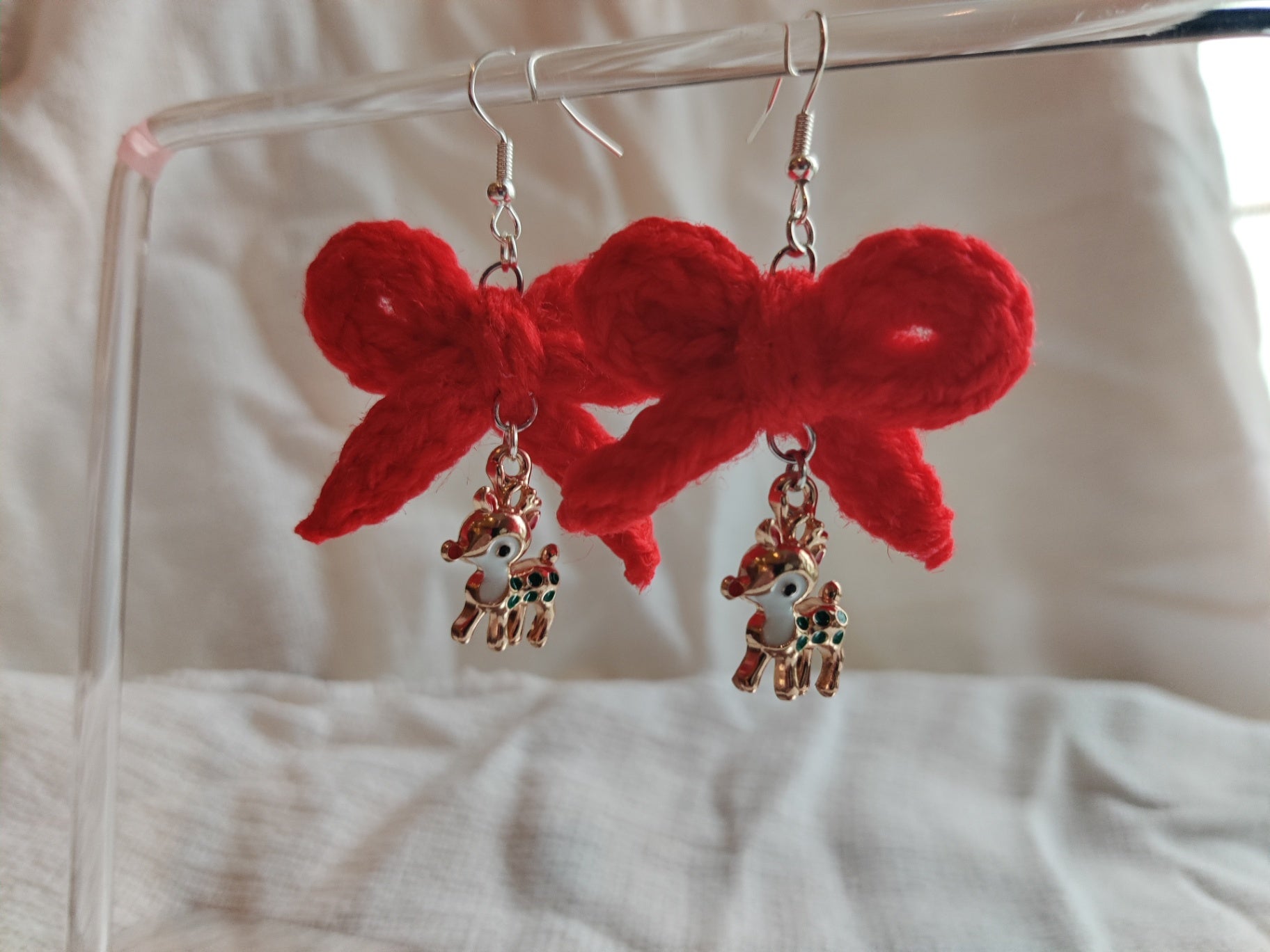 Crochet red bow earrings with reindeer charms