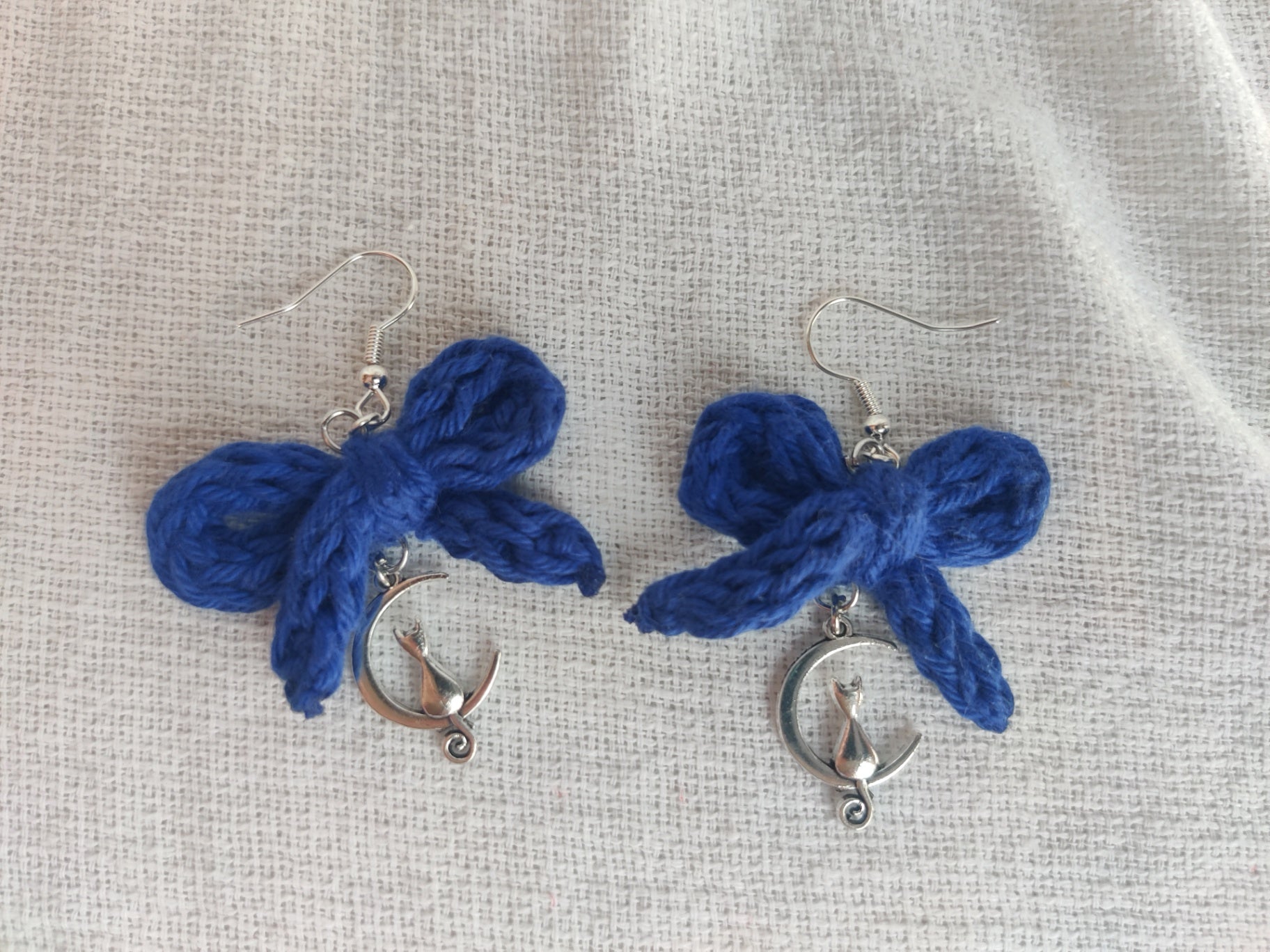 Crochet blue bow earrings with silver cat pendant
