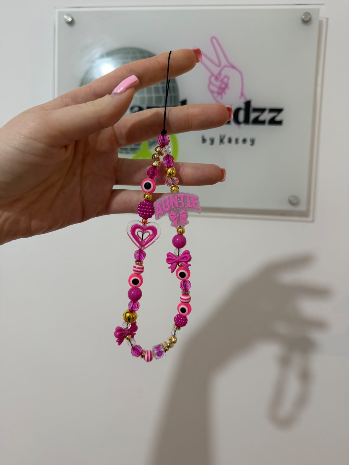 Pink ‘Auntie’ phone charm - gold
