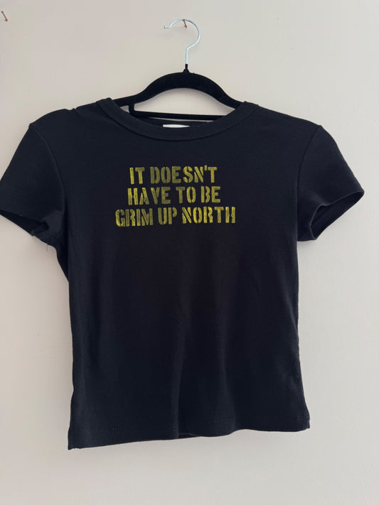 it doesn’t have to be grim up north baby tee