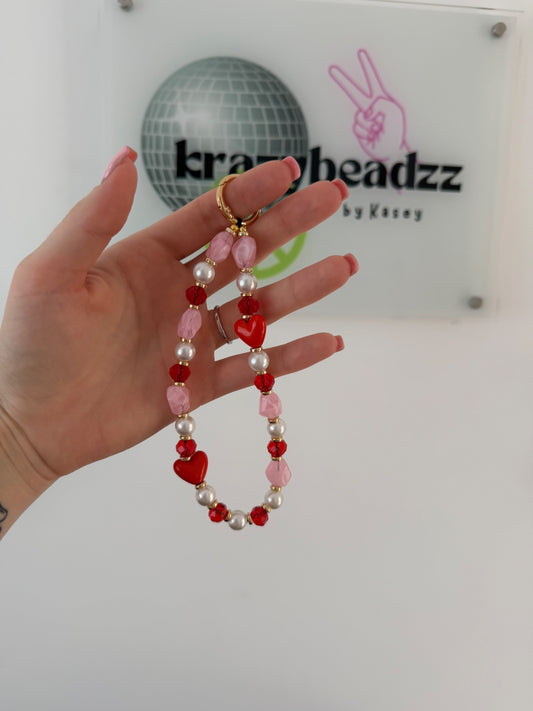 ‘Love is all around’ phone charm -pink/red